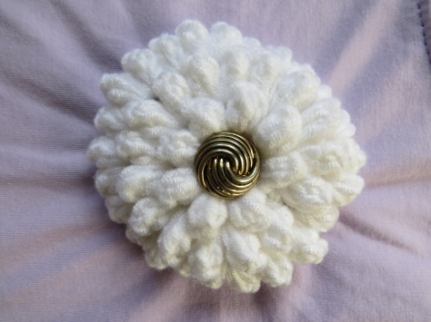 White crochet flower with button